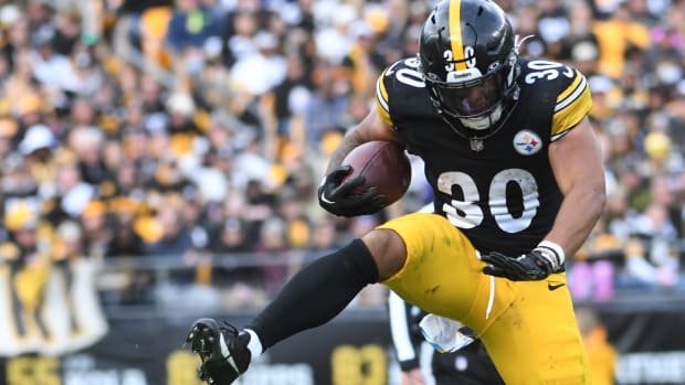 Oct 8, 2023; Pittsburgh, Pennsylvania, USA; Pittsburgh Steelers running back Jaylen Warren (30) leaps over Baltimore Ravens cornerback Ronald Darby (28) during a 16 yard run in the fourth quarter at Acrisure Stadium. The Steelers won 17-10. Mandatory Credit: Philip G. Pavely-USA TODAY Sports